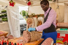 Black man preparing sausage at the market